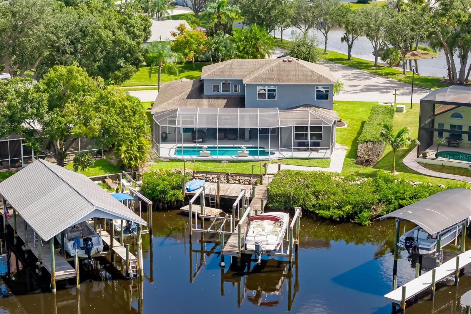 Back Elevation - Culdesac on Canal - Two Boat lifts and a floating dock for accessing Kayaks - 124 41ST CIR E, BRADENTON