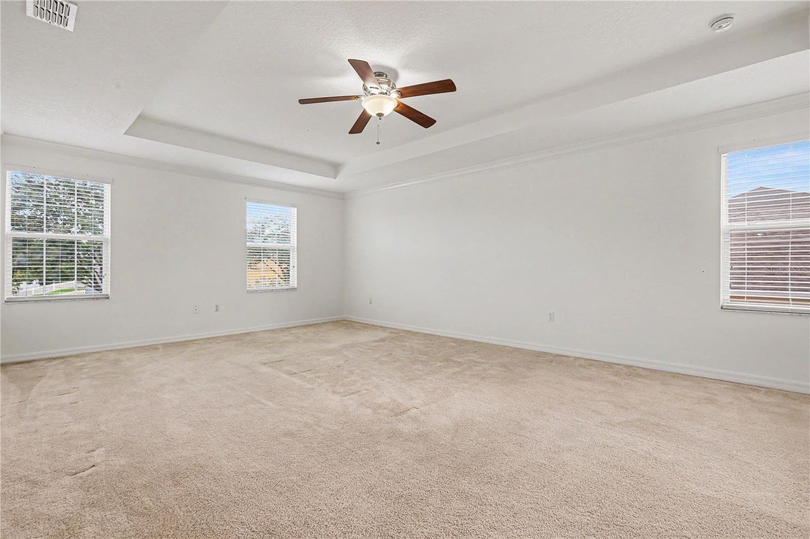 spacious primary master bedroom with tray ceilings on second floor - 580 L M DAVEY LN, TITUSVILLE