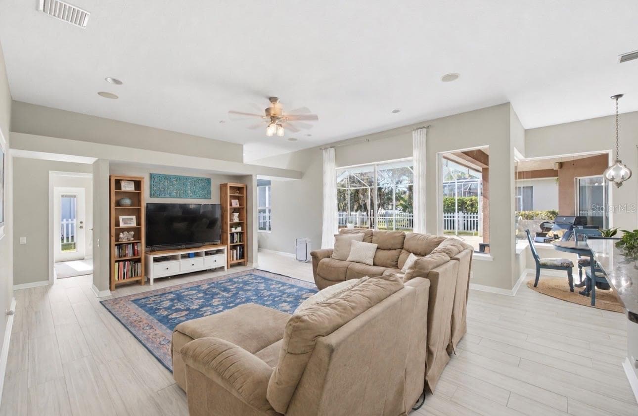 Secondary Den/Living Room behind the kitchen, with sliding doors to exterior. - 3905 SORREL VINE DR, WESLEY CHAPEL