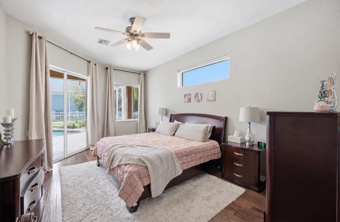 Primary Suite with sliders out to the pool area, high ceilings, huge walk in closet, huge bathroom, and storage. - 3905 SORREL VINE DR, WESLEY CHAPEL