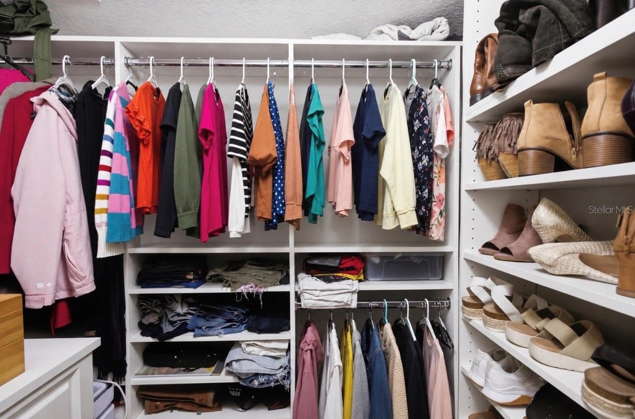 Primary Suite Walk in Closet with customized closet systems. - 3905 SORREL VINE DR, WESLEY CHAPEL