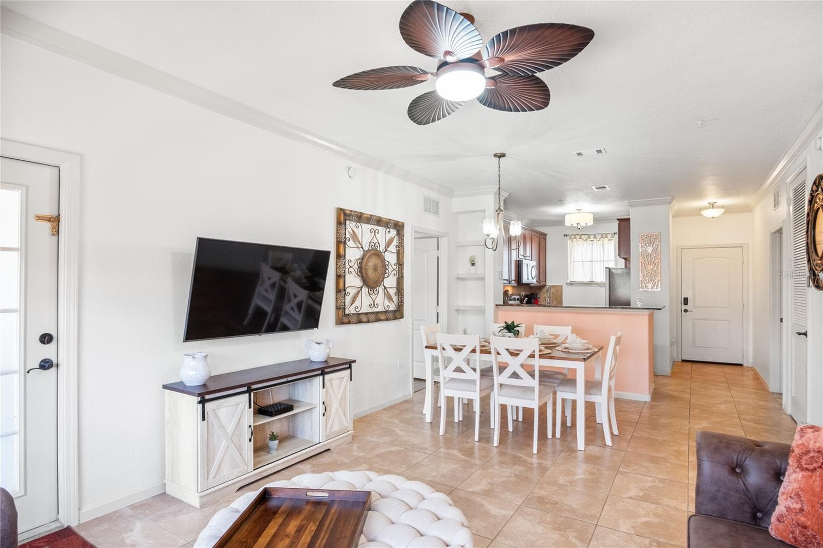 View from the rear of the unit showcasing the living room, dining area and kitchen. - 912 CHARO PKWY #232, DAVENPORT