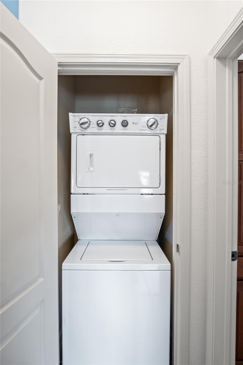 Stackable washer and dryer located in the unit - 912 CHARO PKWY #232, DAVENPORT