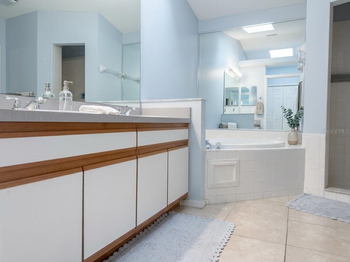 En-suite primary bathroom features ceramic tile, garden tub, and shower. - 989 HAMLET CT, MAITLAND