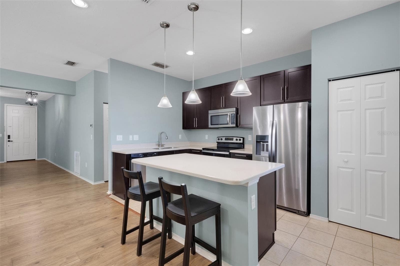 Kitchen featuring Corian Countertops, Breakfast Bar, Soft Close Cabinetry, Stainless Steel Appliances, Closet Pantry - 11126 GOLDENROD FERN DR, RIVERVIEW