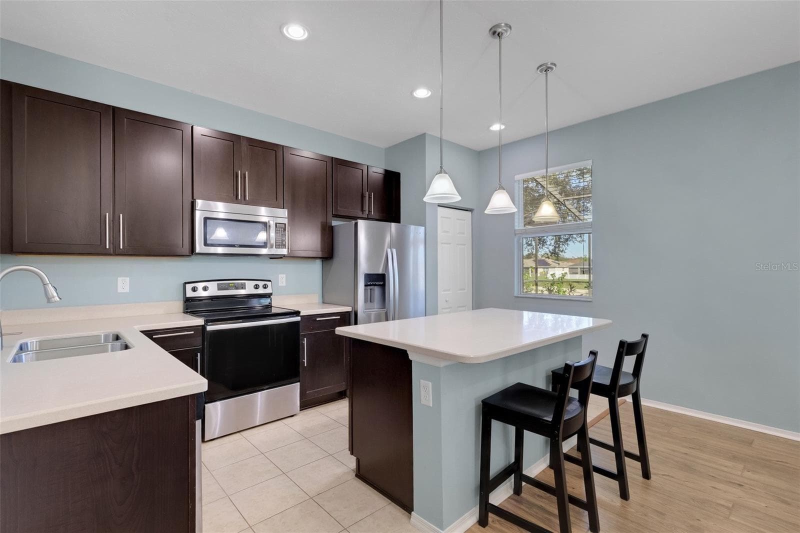 Kitchen featuring Corian Countertops, Breakfast Bar, Soft Close Cabinetry, Stainless Steel Appliances, Closet Pantry - 11126 GOLDENROD FERN DR, RIVERVIEW