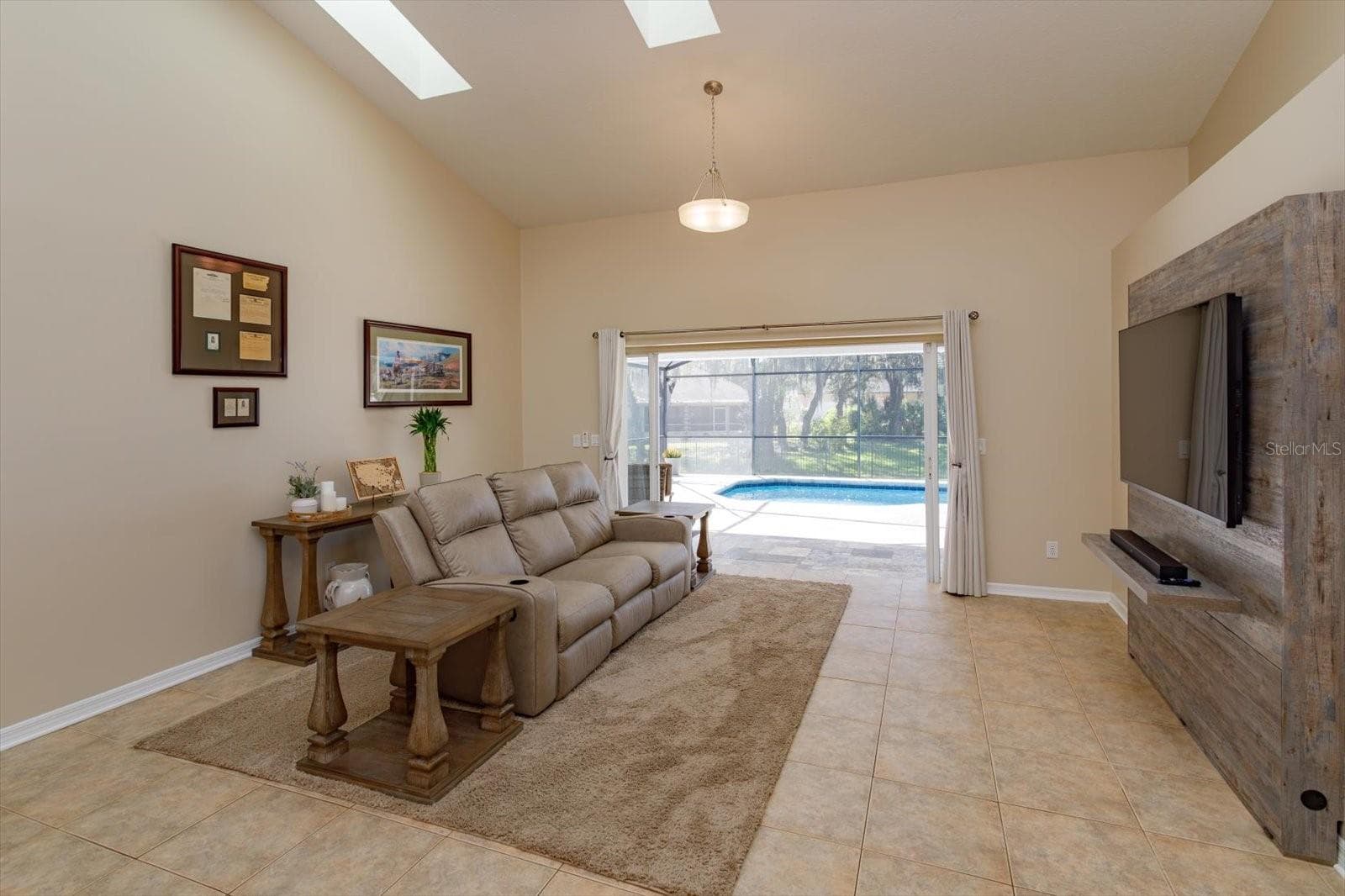 Freshing painted family room features double pocket sliding doors to the covered porch - 6887 HIDDEN GLADE PL, SANFORD