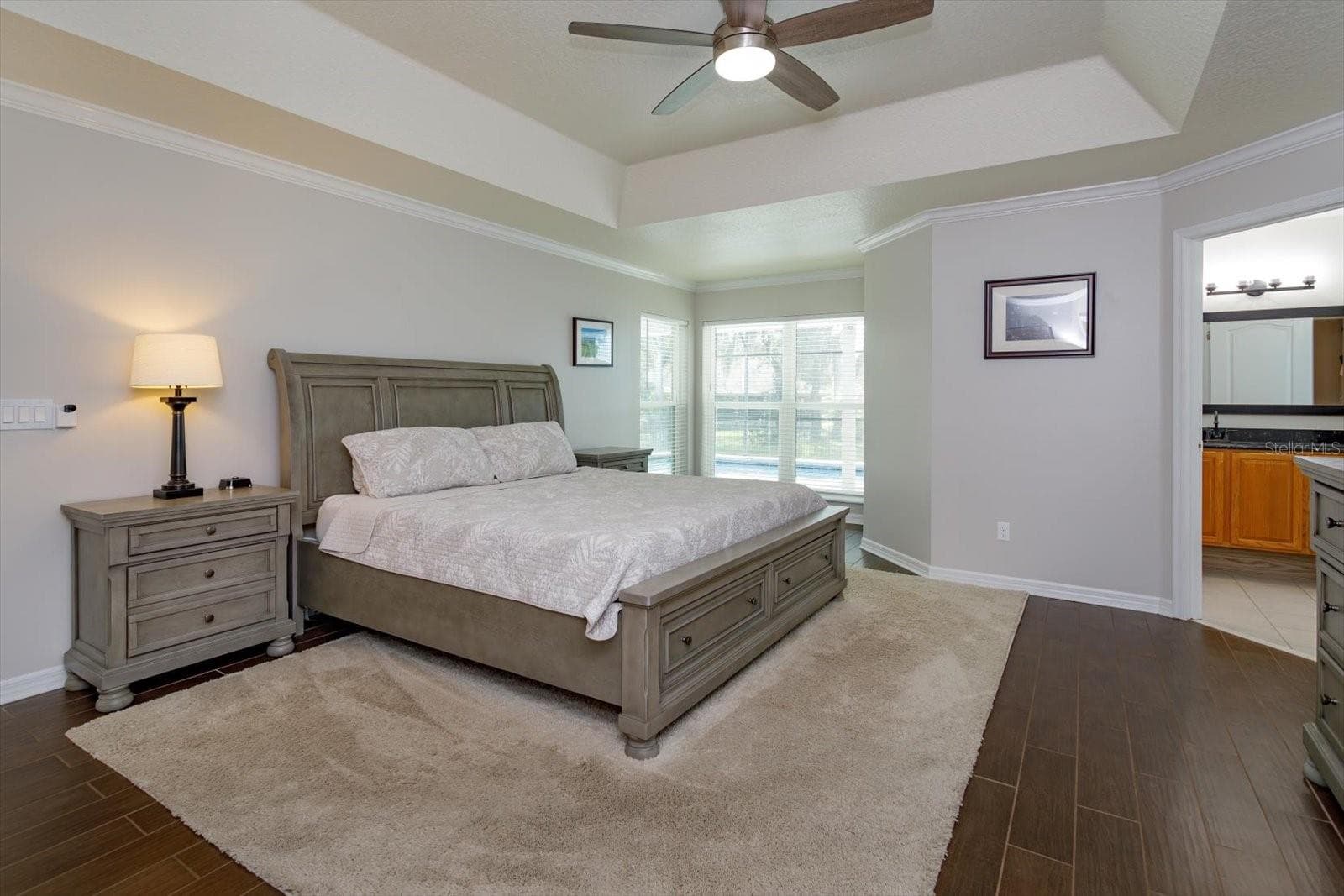 Freshly painted primary bedroom with sitting area and wood look tile - 6887 HIDDEN GLADE PL, SANFORD