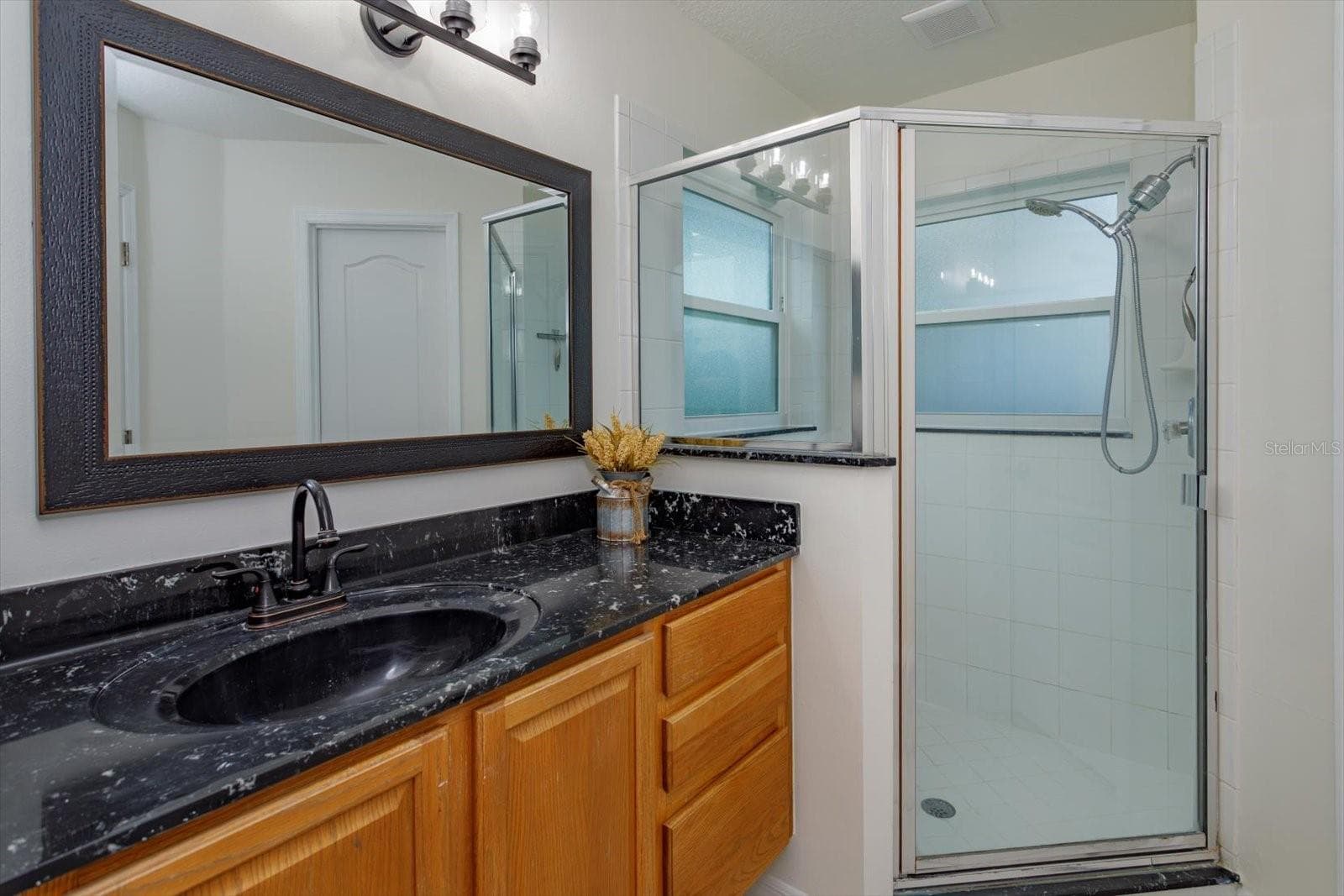His primary bathroom features walk in shower and private water closet - 6887 HIDDEN GLADE PL, SANFORD