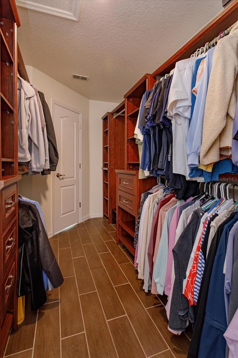 Custom walk in closet with floor safe in the primary suite - 6887 HIDDEN GLADE PL, SANFORD