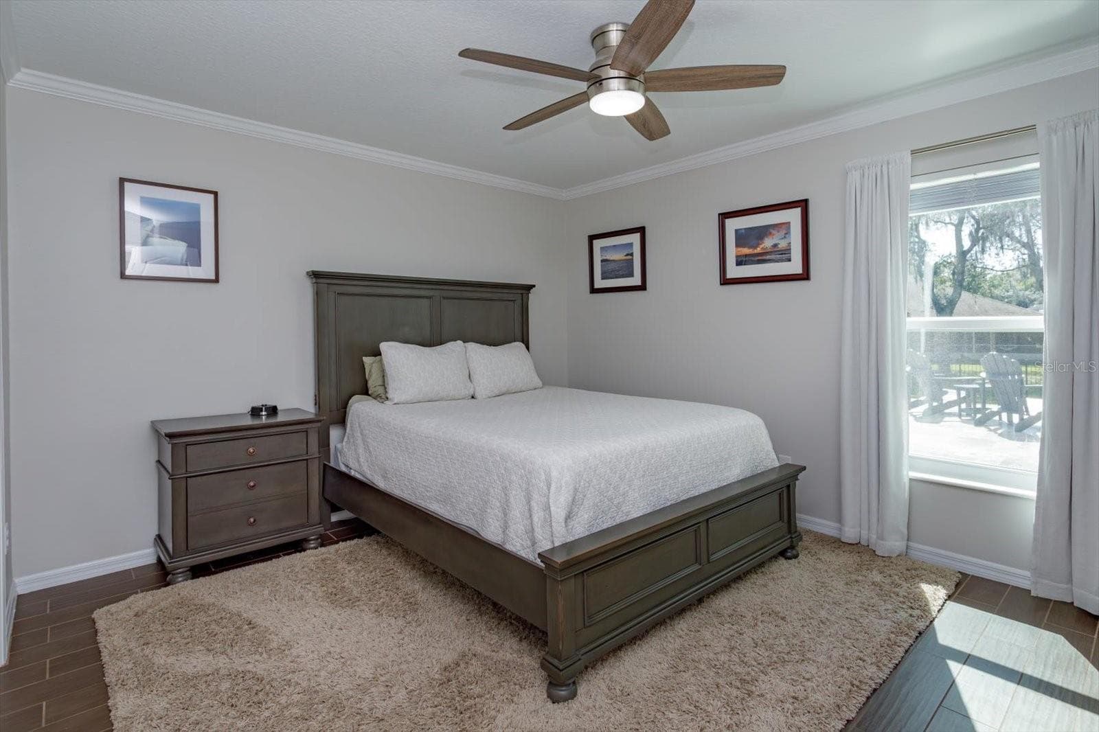 Freshly painted bedroom 2 features new fan, new blinds and wood look tile floors - 6887 HIDDEN GLADE PL, SANFORD