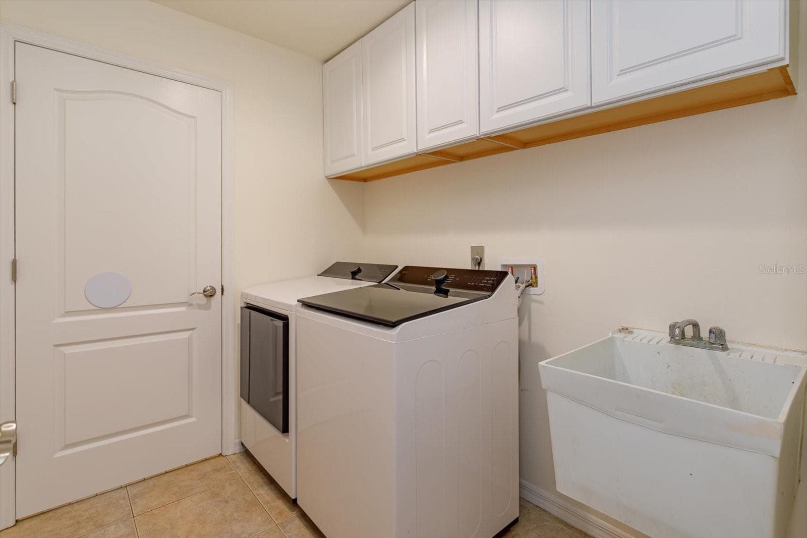 Laundry room with built in cabinets and sink - 6887 HIDDEN GLADE PL, SANFORD