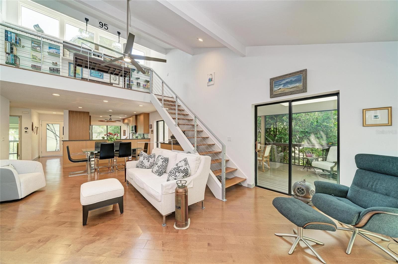 Open floor plan with living/dining, stairs to the loft and kitchen under the loft. - 2403 ARBORETUM CIR #29, SARASOTA