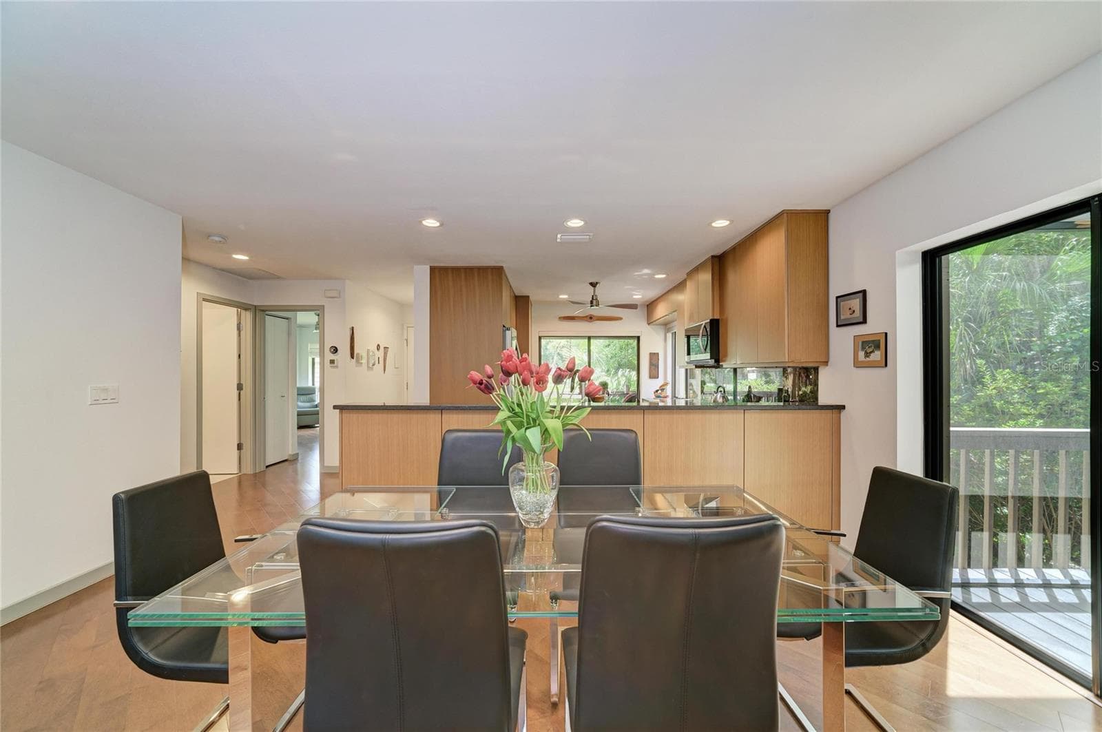 Dining area with sliders to covered and screened lanai. - 2403 ARBORETUM CIR #29, SARASOTA