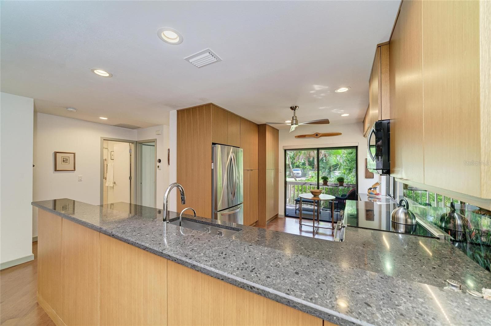 Kitchen with sliders to the front screened porch - 2403 ARBORETUM CIR #29, SARASOTA