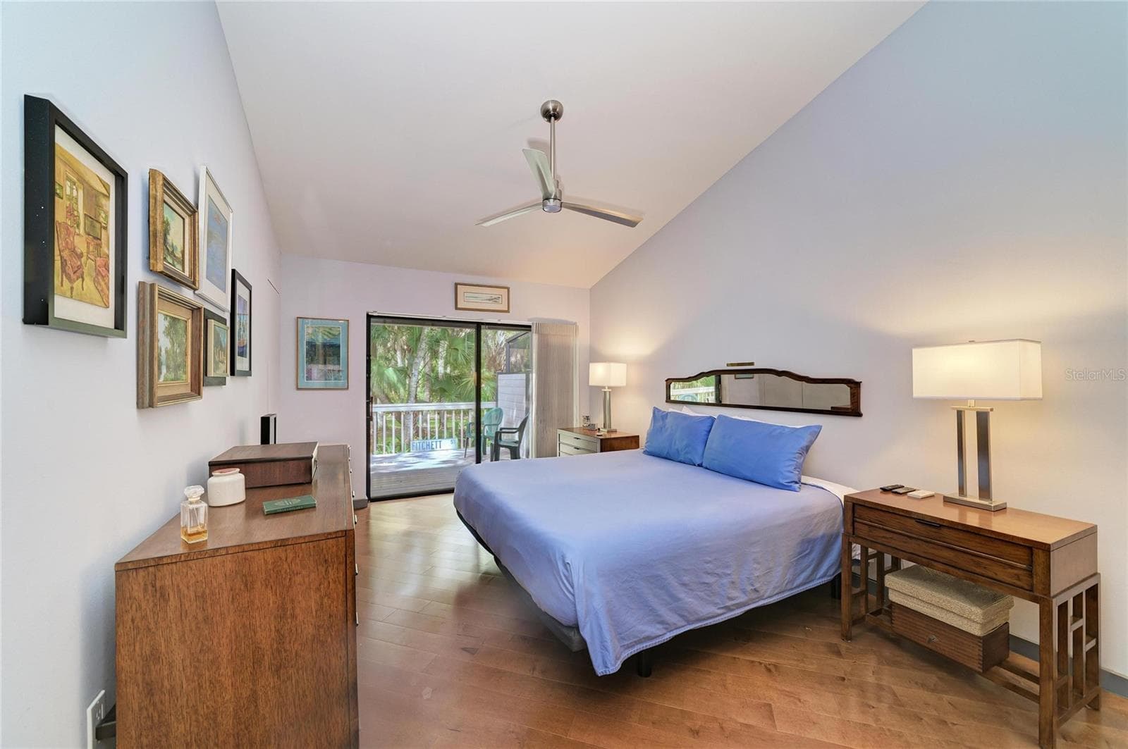 Primary bedroom with sliders out to the open back deck - 2403 ARBORETUM CIR #29, SARASOTA