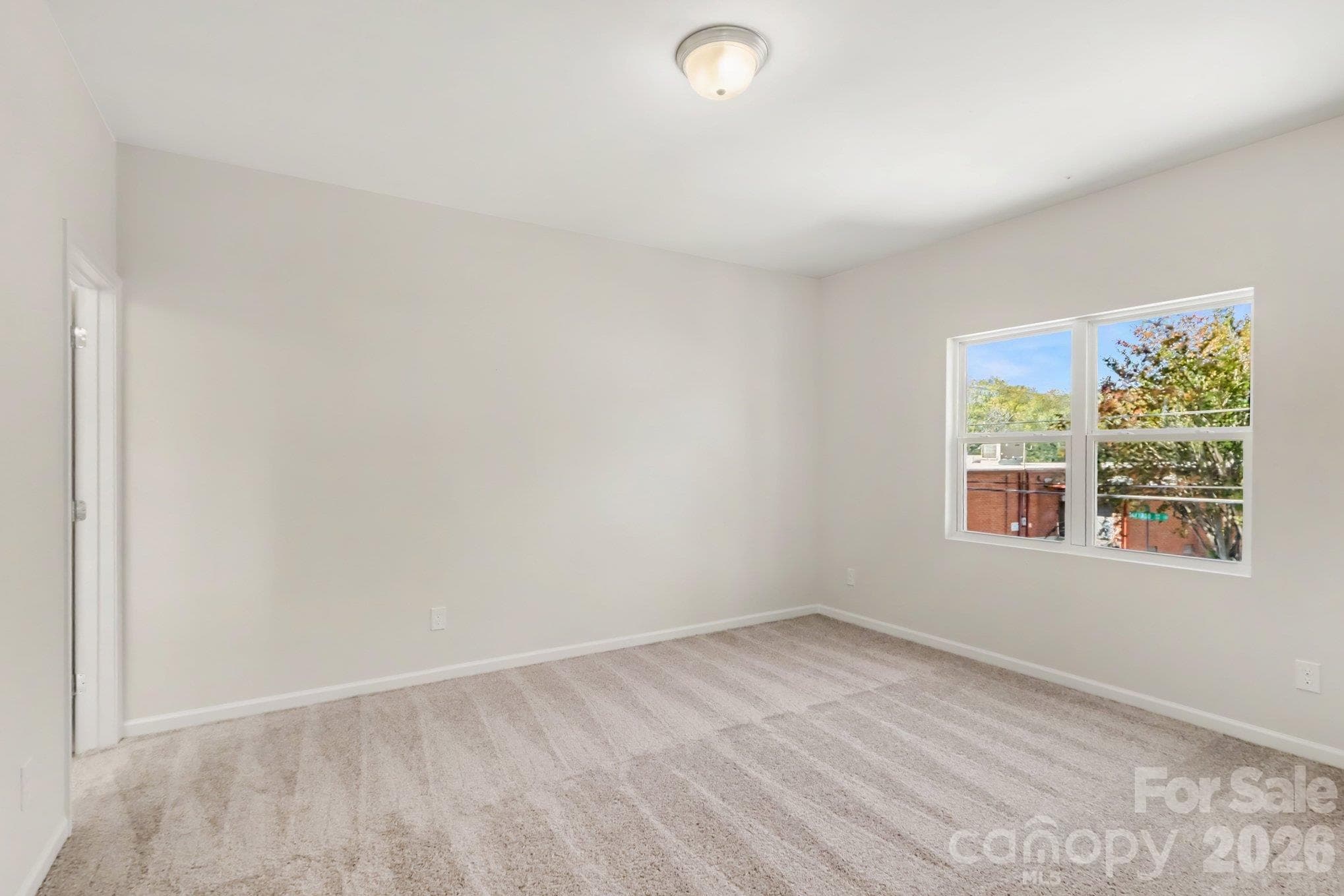 Primary bedroom on upper level with carpet flooring. Actual non-staged photo. - 125 Buffalo Avenue NW, Concord