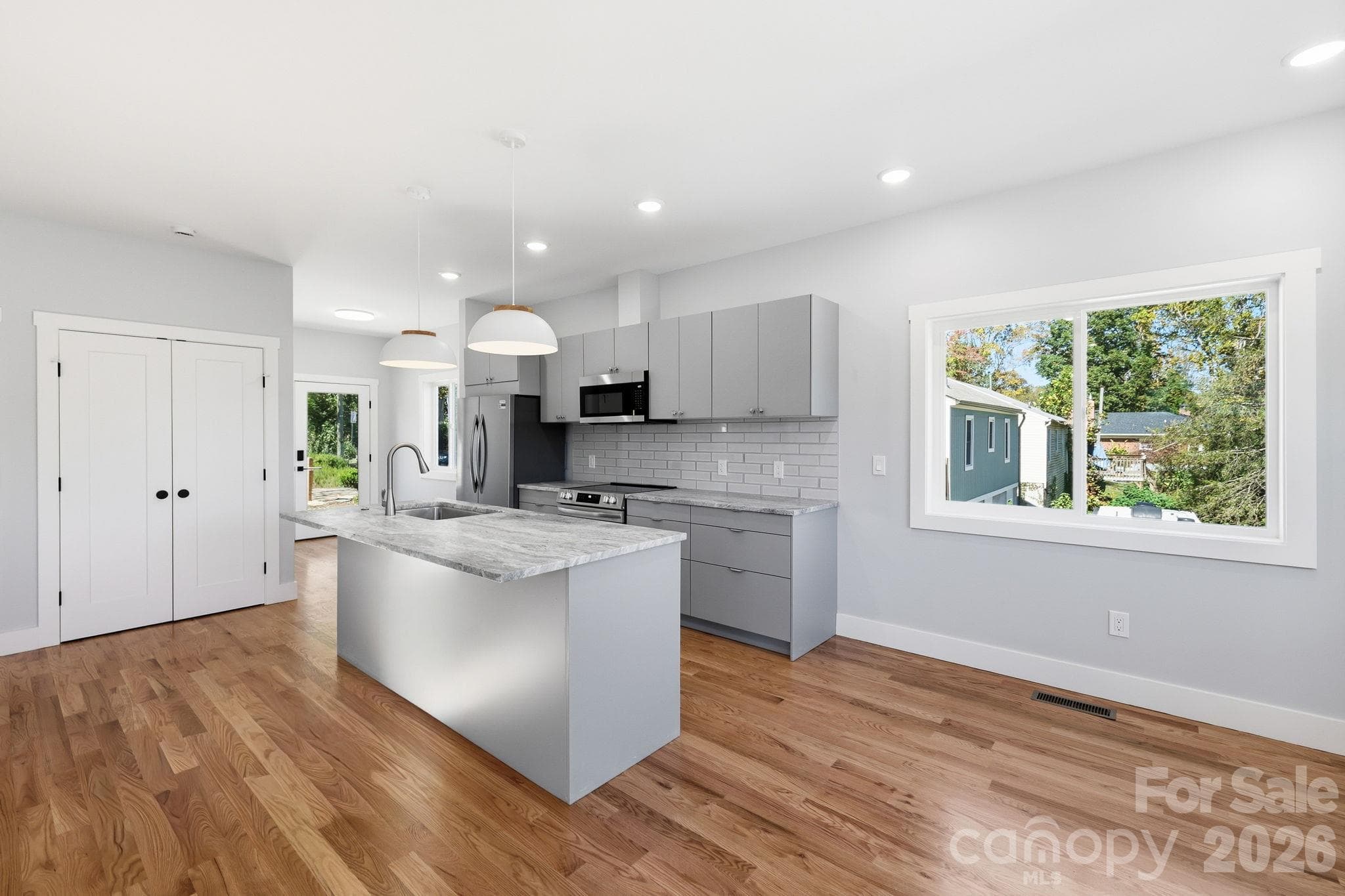 Hardwood floors flow throughout the kitchen and dining area - 20 Laurel Loop, Asheville