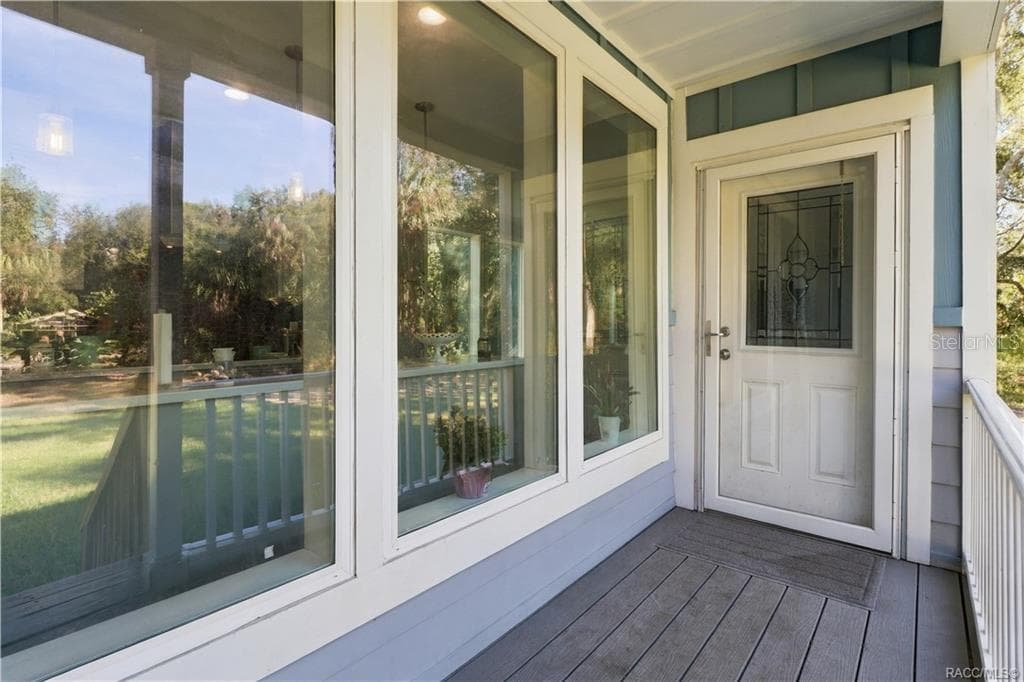A WELCOMING FIRST IMPRESSION! The covered entry features attractive windows, white railings & a decorative glass front door that adds character. - 7528 N CHABAUD TER, CRYSTAL RIVER