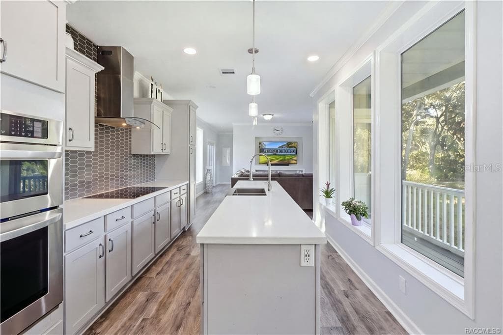 THE KITCHEN IS THE SHOWSTOPPER! Beautiful GRAY CABINETRY, expansive countertops, a generous CENTER ISLAND, stainless steel appliances & pendant lighting create an impressive gathering space. - 7528 N CHABAUD TER, CRYSTAL RIVER