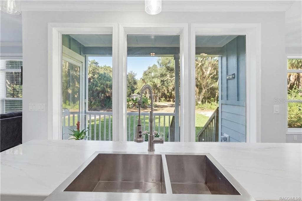 IT'S ALL IN THE DETAILS! A stylish GRAY GEOMETRIC TILE BACKSPLASH, electric cooktop & modern stainless steel range hood add personality to the kitchen. - 7528 N CHABAUD TER, CRYSTAL RIVER