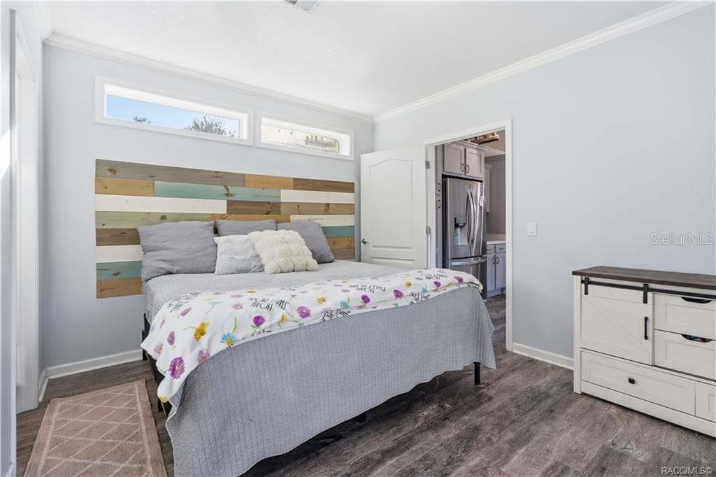 YOUR OWN COMFORTABLE RETREAT! The PRIMARY BEDROOM features beautiful natural light, neutral finishes, LUXURY VINYL PLANK FLOORING & a distinctive wood-accent headboard. - 7528 N CHABAUD TER, CRYSTAL RIVER