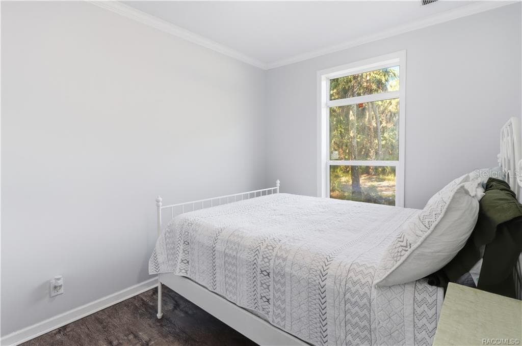 WAKE UP TO NATURE! Another view of the bedroom showcases natural light, attractive flooring & peaceful views of the surrounding trees. - 7528 N CHABAUD TER, CRYSTAL RIVER