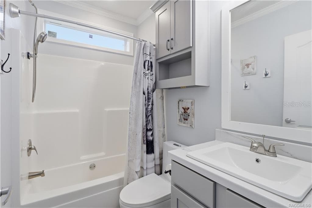 STYLE & EVERYDAY CONVENIENCE! The SECOND FULL BATHROOM features a GRAY VANITY, framed mirror, additional wall cabinetry & a TUB/SHOWER COMBINATION. - 7528 N CHABAUD TER, CRYSTAL RIVER