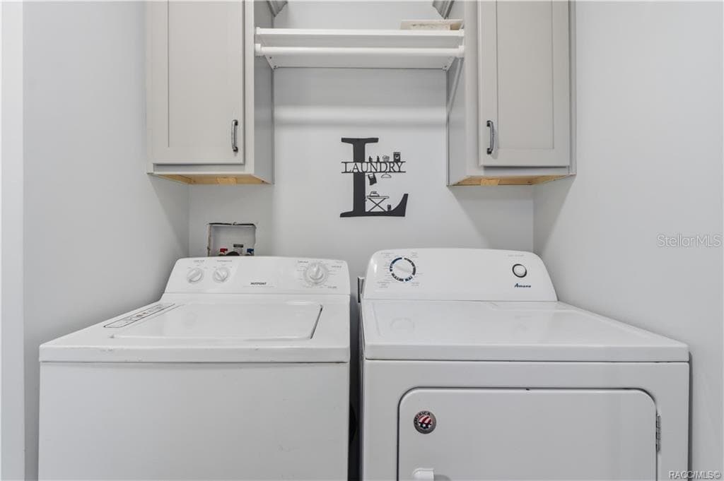 LAUNDRY MADE CONVENIENT! The INDOOR LAUNDRY AREA features a washer, dryer, overhead GRAY CABINETRY & shelving for additional storage. - 7528 N CHABAUD TER, CRYSTAL RIVER