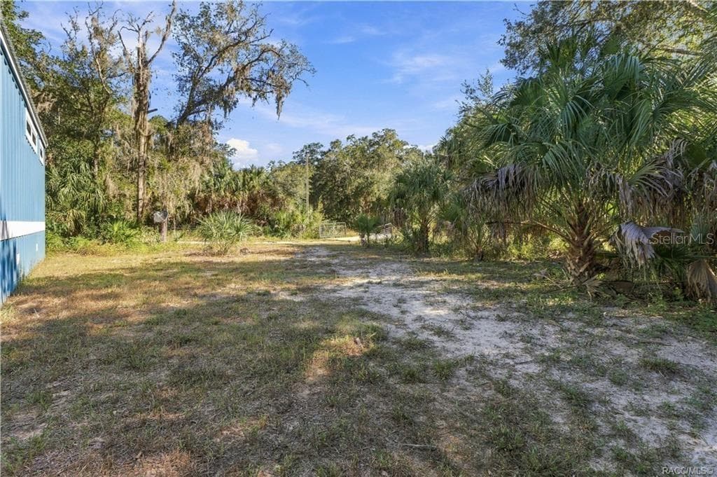 BRING YOUR TOYS & ENJOY THE SPACE! The 1.42-ACRE FULLY FENCED PROPERTY offers open areas, mature trees, Florida palms & a gated entrance. - 7528 N CHABAUD TER, CRYSTAL RIVER