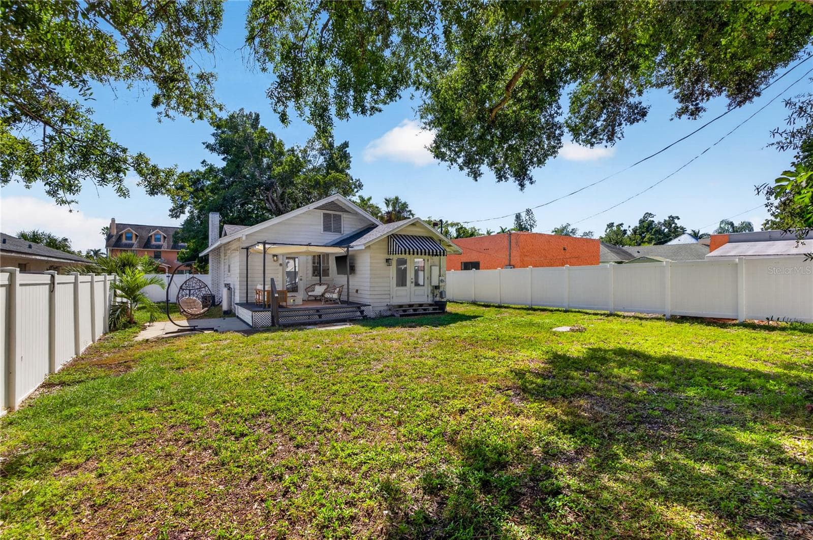 Views of the back of the house in the newly fenced in backyard - 2106 8TH AVE W, BRADENTON
