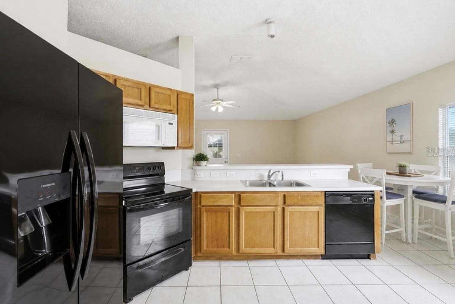 Virtually staged with the home's actual furniture - kitchen and dining - 3 LOUVET LN, PALM COAST