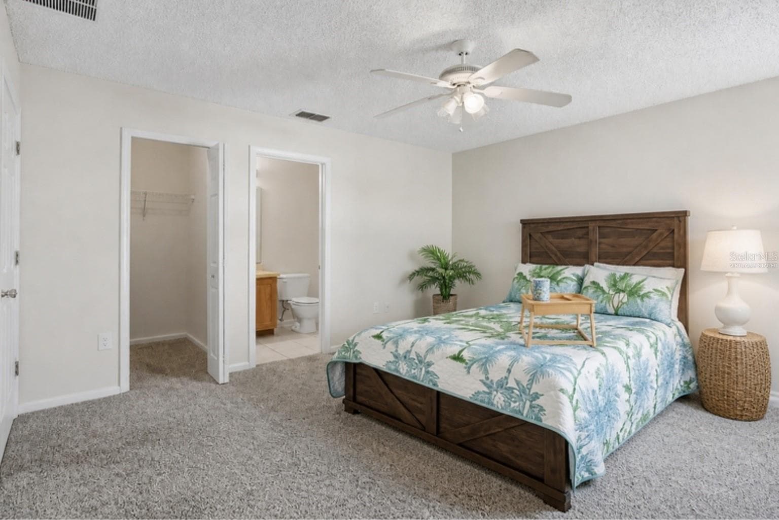 Virtually staged with the home's actual furniture - primary bedroom, walk-in closet and bath - 3 LOUVET LN, PALM COAST