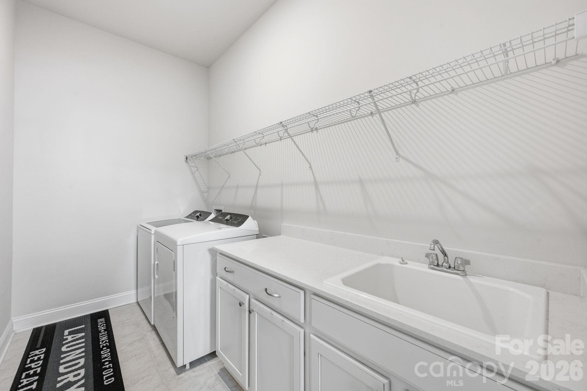 Main level laundry has storage and large sink - 4025 Pollock View, Mount Holly