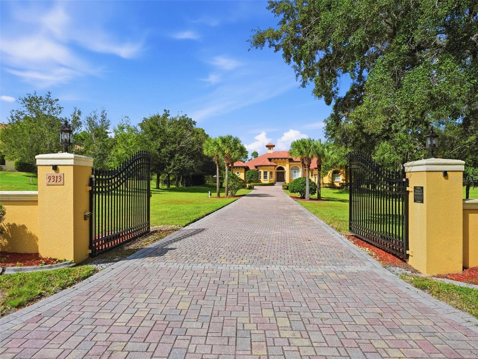 Private gated entrance to the estate with long brick paver driveway! No detail left untouched! - 9313 HERNANDO RIDGE RD, WEEKI WACHEE