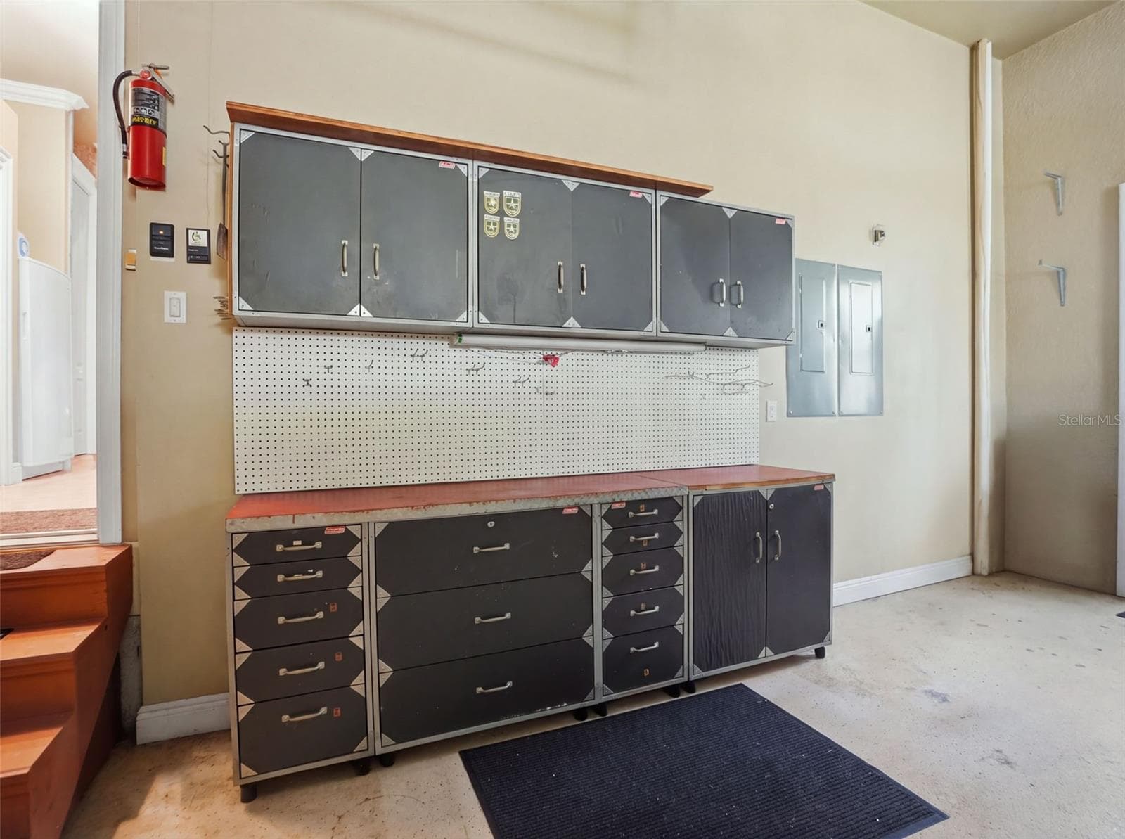 Workshop table and cabinets in the 3-car garage. - 9313 HERNANDO RIDGE RD, WEEKI WACHEE