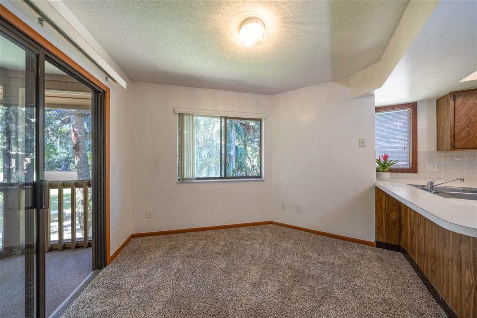 Sliders From The Kitchen Open To The Screened Patio Overlooking The Golfcourse - 12 FAIRWAYS CIR #12, PALM COAST