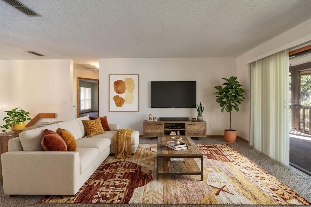 VIRTUALLY STAGED: Living Area With Sliders That Open Into The Screened Patio - 12 FAIRWAYS CIR #12, PALM COAST