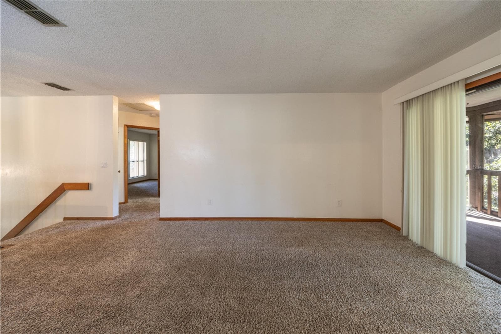 UNSTAGED: Carpeted Living Area. Professionally Cleaned - 12 FAIRWAYS CIR #12, PALM COAST