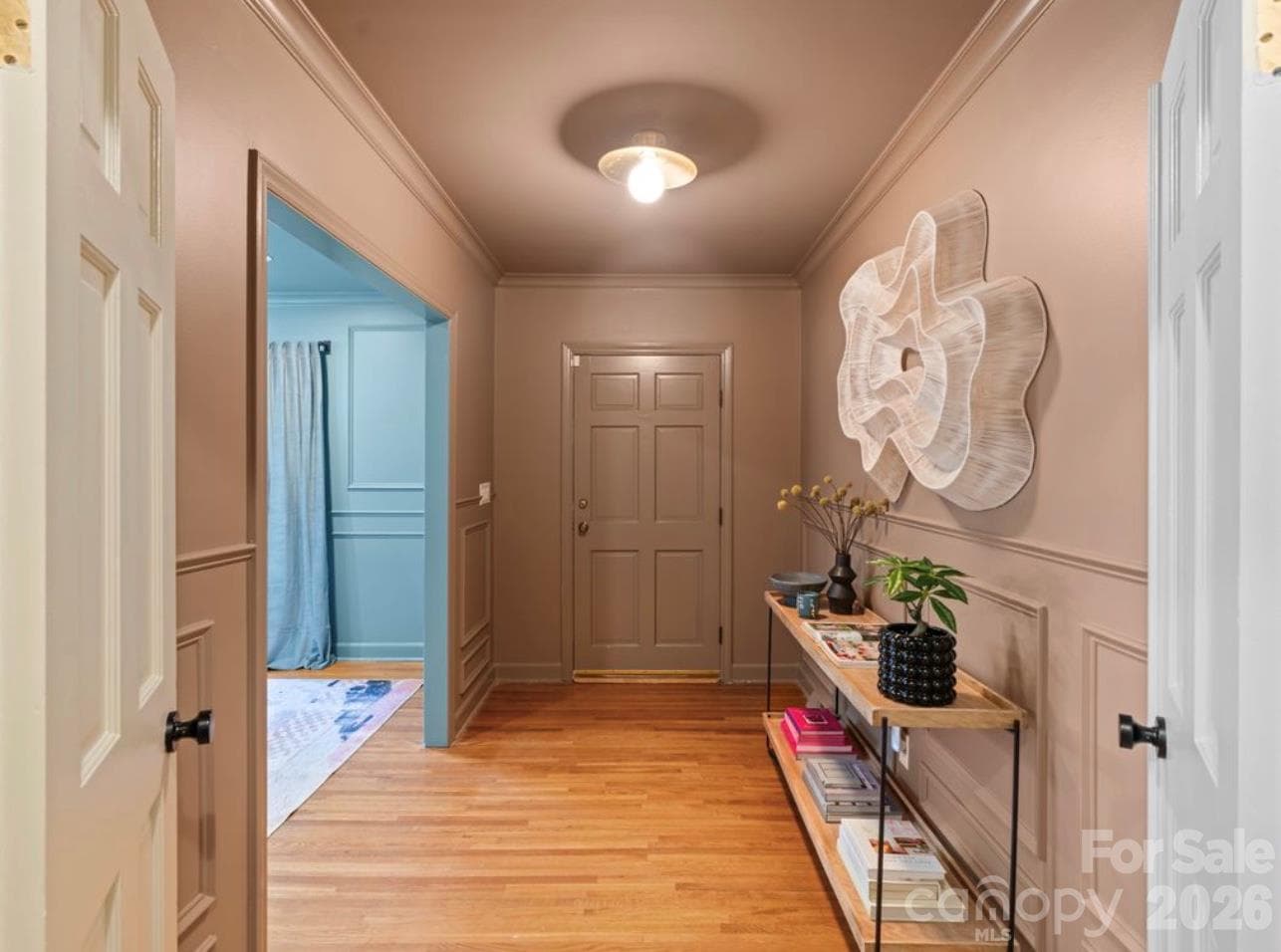 Welcoming foyer with hardwood floors, picture frame molding, new lighting and freshly painted - 6626 Rocky Falls Road, Charlotte