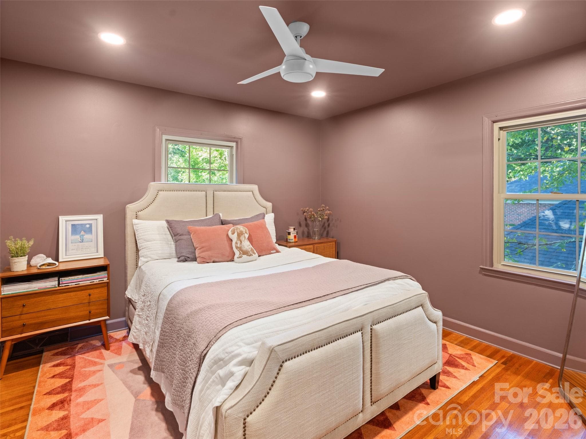 The second bedroom on the main level features fresh ceiling-to-floor paint, convenient storage, and an updated ceiling fan, creating a refreshed and inviting space - 6626 Rocky Falls Road, Charlotte