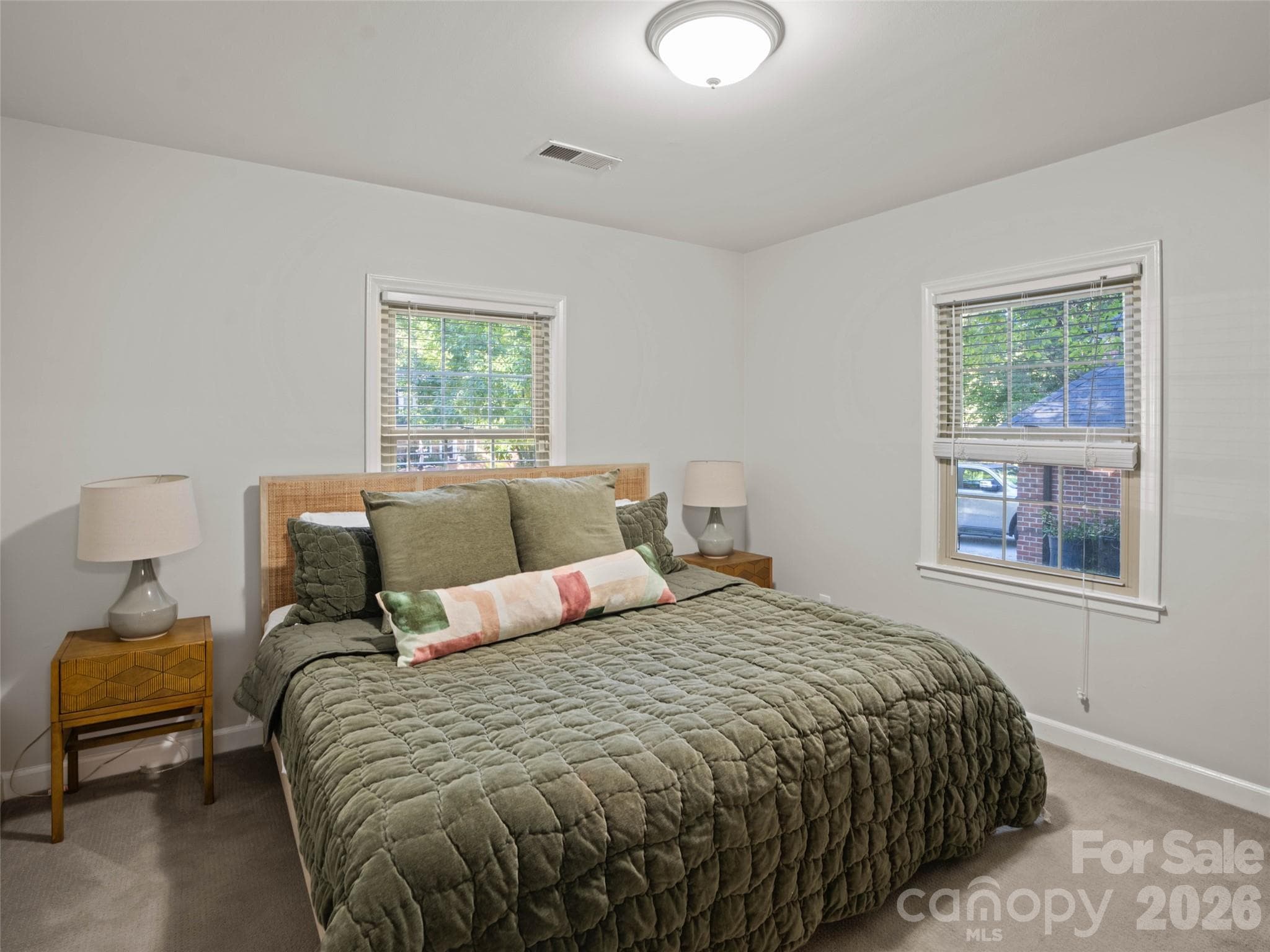 The generously sized fourth bedroom is conveniently located just off the second living area in the basement, offering the perfect private retreat for guests or extended family. Beautiful carpeting, fresh paint, a large closet, and windows that welcome in abundant natural light make this the larger of the two basement bedrooms. - 6626 Rocky Falls Road, Charlotte