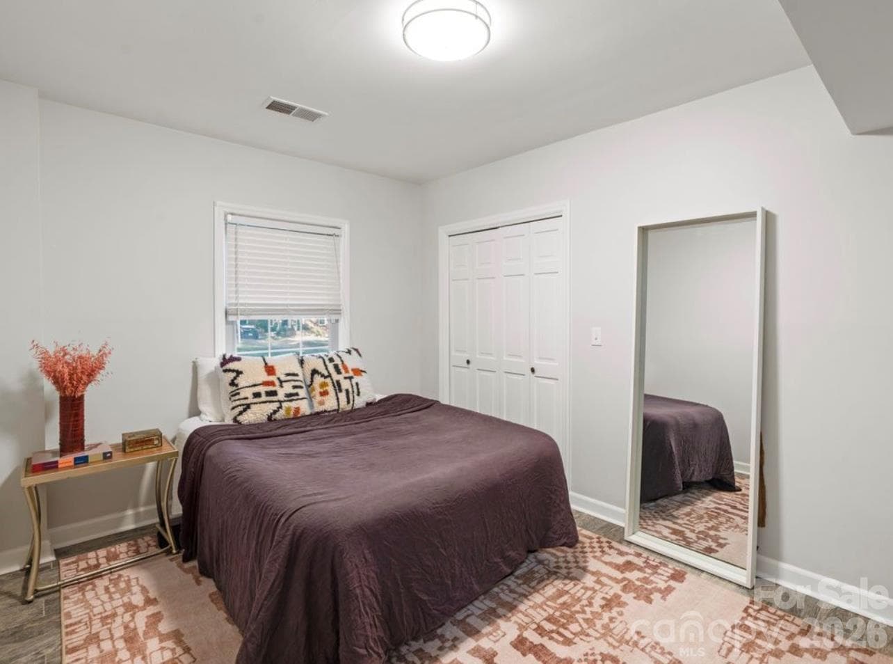The fifth bedroom offers a bright, refreshed space featuring new tile flooring, fresh paint, a spacious closet, and natural light. - 6626 Rocky Falls Road, Charlotte