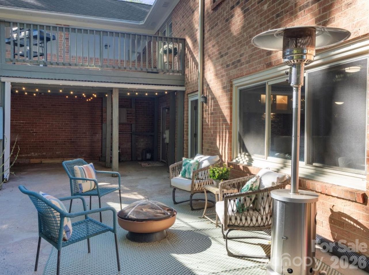 Enjoy the elevated deck overlooking the charming lower-level patio, offering a wonderful view of the outdoor living spaces below. The covered area beneath the deck provides endless possibilities, whether you need additional storage, a shaded spot for an outdoor dining table, or a place to enjoy games and gatherings. A versatile outdoor setup designed for both relaxation and entertaining! - 6626 Rocky Falls Road, Charlotte