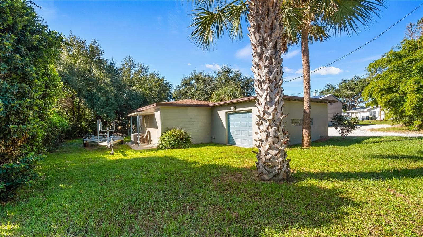 Detached garage and apartment. 2 car parking plus storage. Driveway off Lakeshore drive, little fenced in back yard. Full kitchen, laundry closet. remodeled. Pre wired for generator plug access so it can be run on a generator. - 1730 NITA PL, CLERMONT