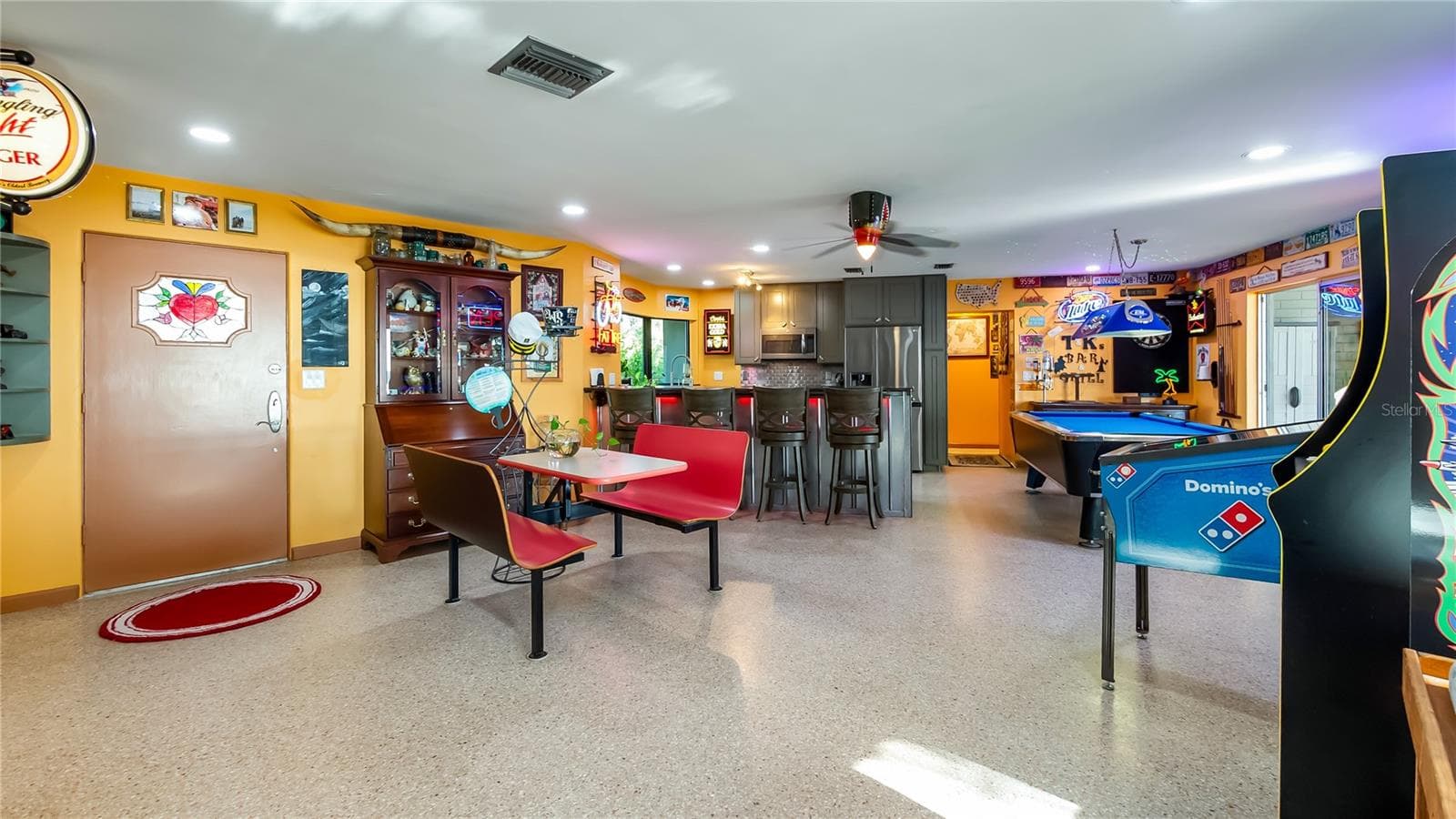 Main Home - Great room/kitchen/living room combo: Living room used as gathering space for game room fun. Two Sliders go out to covered back porch and screened in pool - 1730 NITA PL, CLERMONT