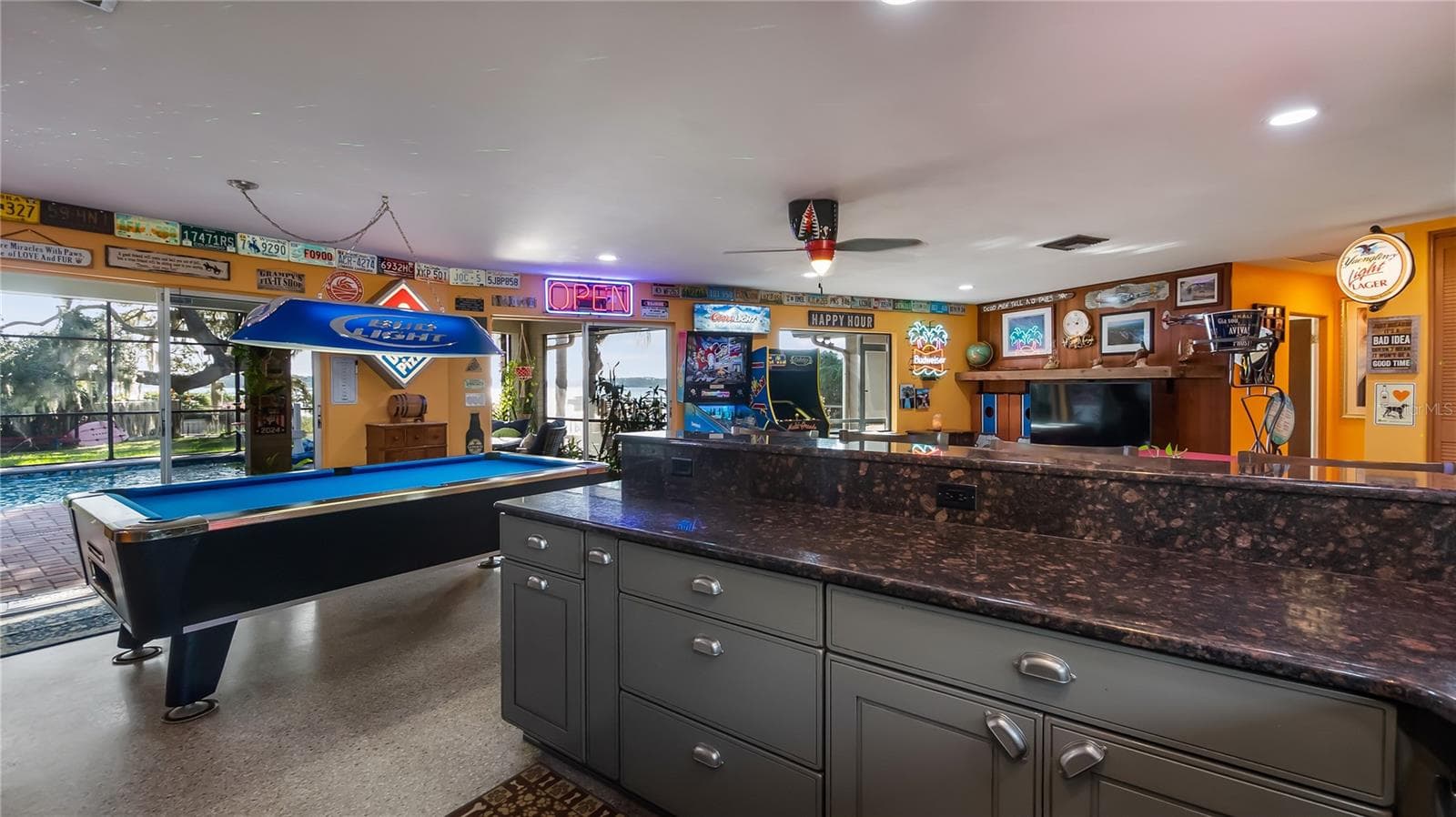 Main Home - Great room/kitchen/living room combo: Living room used as gathering space for game room fun. Two Sliders go out to covered back porch and screened in pool - 1730 NITA PL, CLERMONT