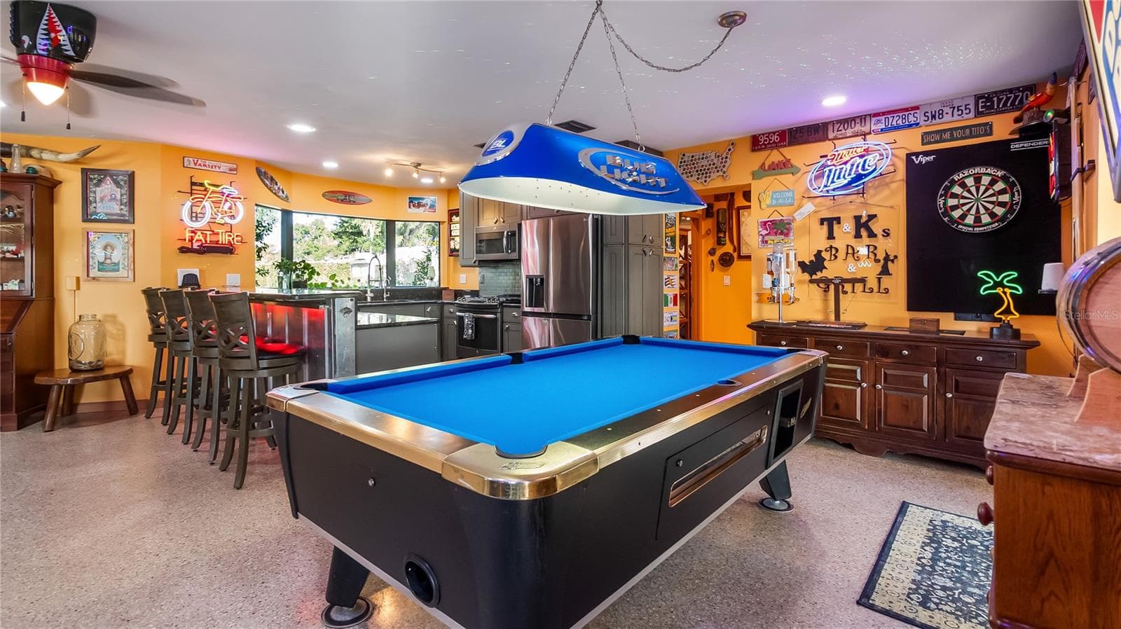 Main Home - Great room/kitchen/living room combo: Living room used as gathering space for game room fun. Two Sliders go out to covered back porch and screened in pool - 1730 NITA PL, CLERMONT