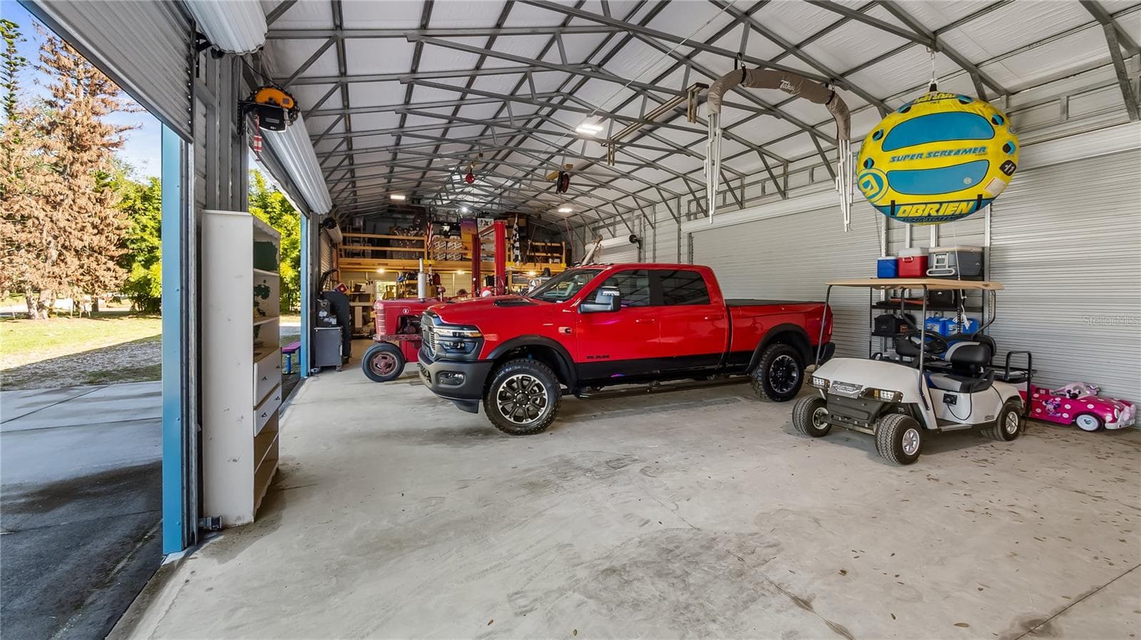 HUGE 30X75 Metal Building installed in October of 2022, has 6 large bay doors, some have electric openers - 1730 NITA PL, CLERMONT