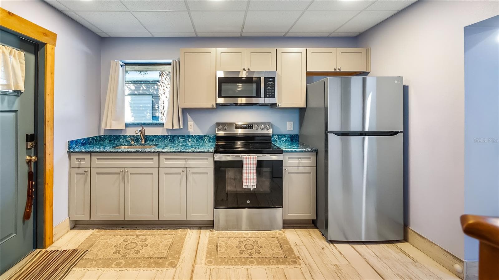 Detached garage and apartment. 2 car parking plus storage. Driveway off Lakeshore drive, little fenced in back yard. Full kitchen, laundry closet. remodeled. Pre wired for generator plug access so it can be run on a generator. - 1730 NITA PL, CLERMONT